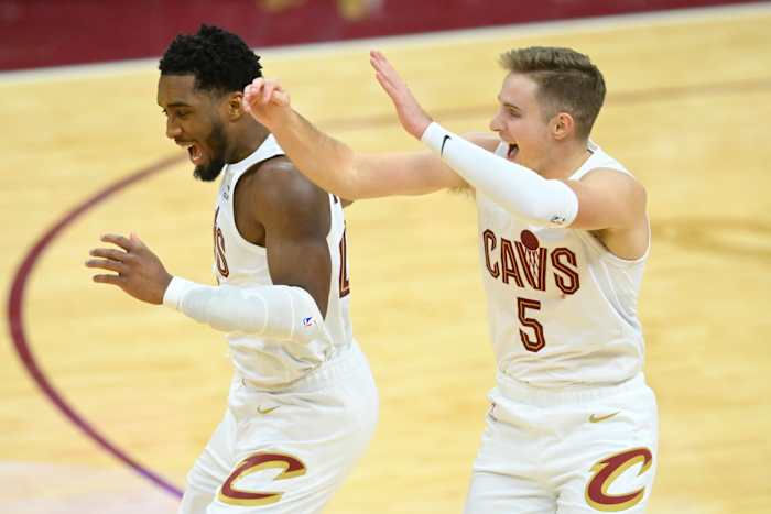 Dec 18, 2023; Cleveland, Ohio, USA; Cleveland Cavaliers guard Donovan Mitchell (45) and guard Sam Merrill (5) celebrate in overtime against the Houston Rockets at Rocket Mortgage FieldHouse.